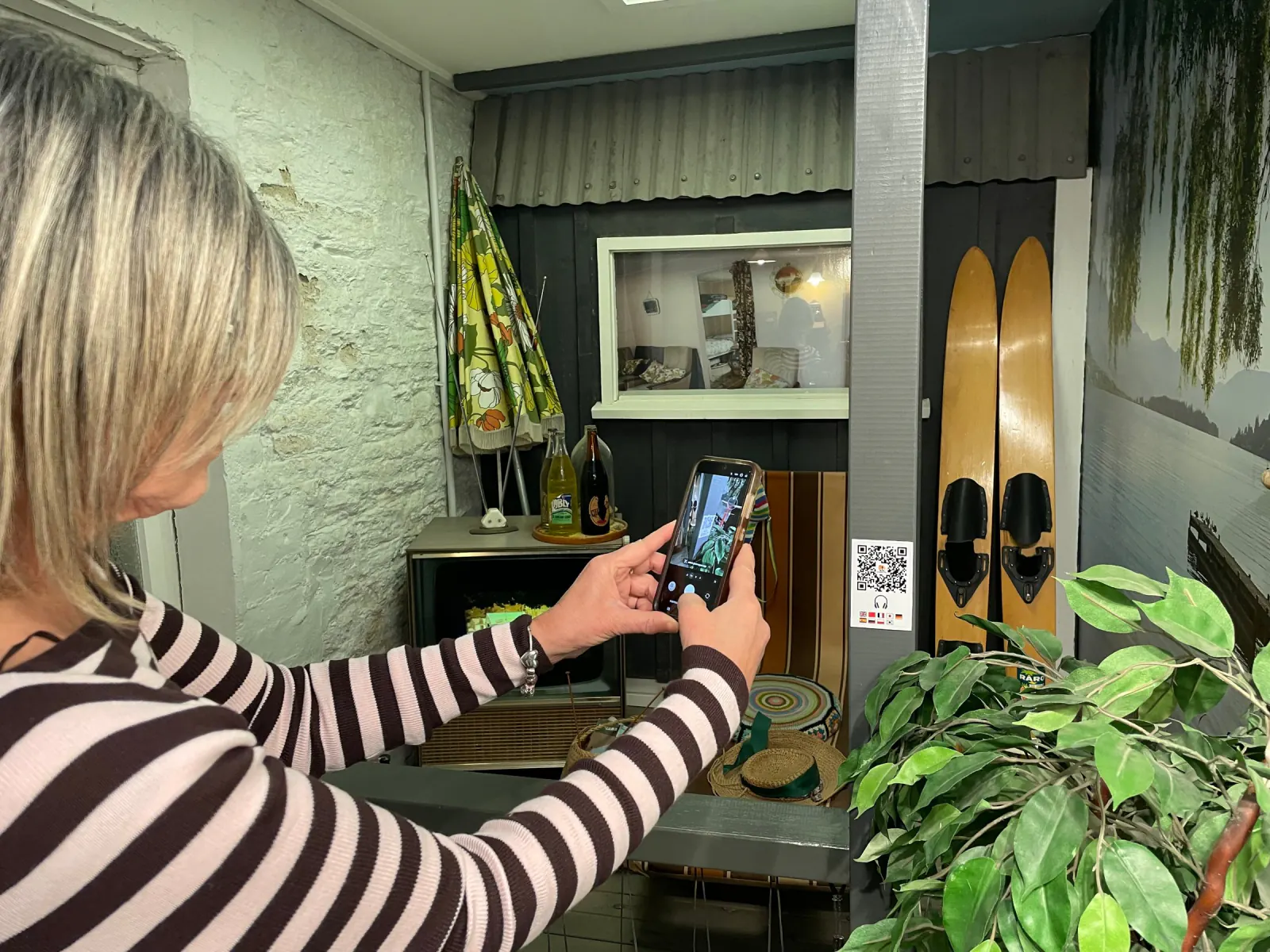 Visitor scanning a Journey Pal QR code at a Lakes District Museum exhibit